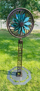Kinetic Wind Sculpture Geometric Tower with Teal and Black Flower Spinner on a Trippy Background